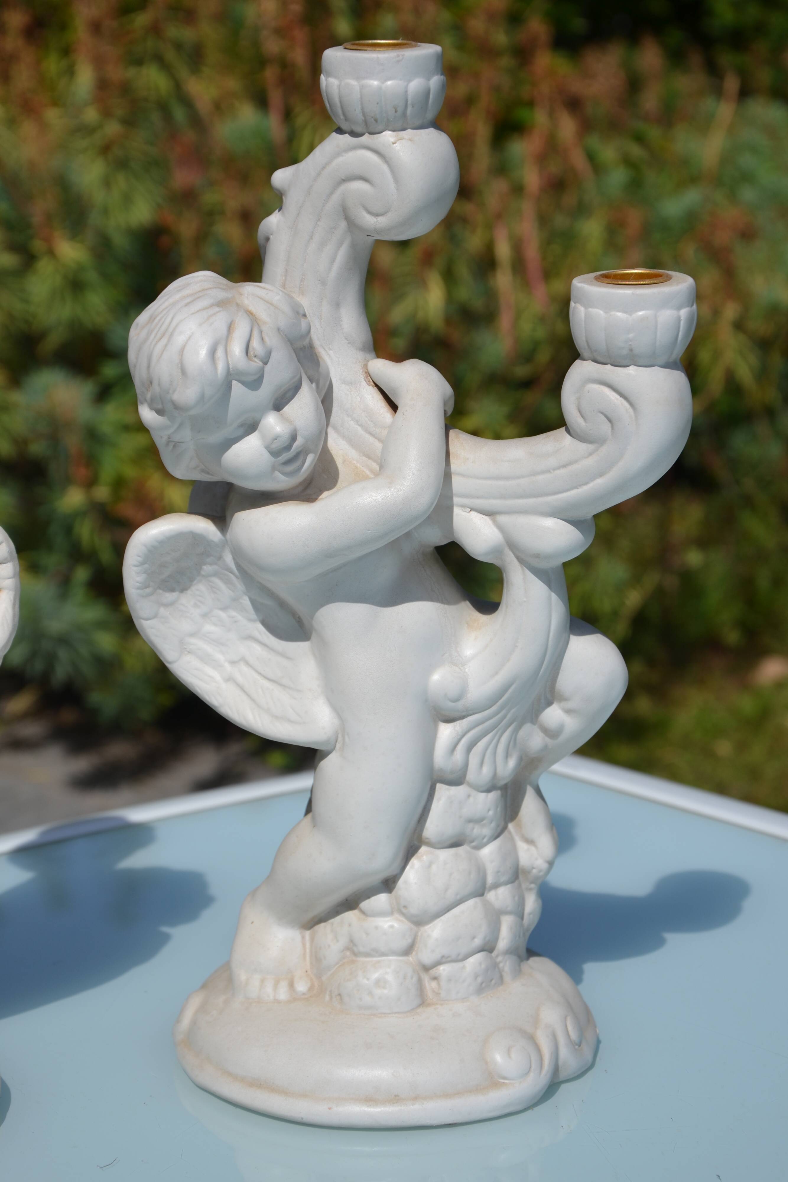 Pair of "cherub" candle holders in plaster