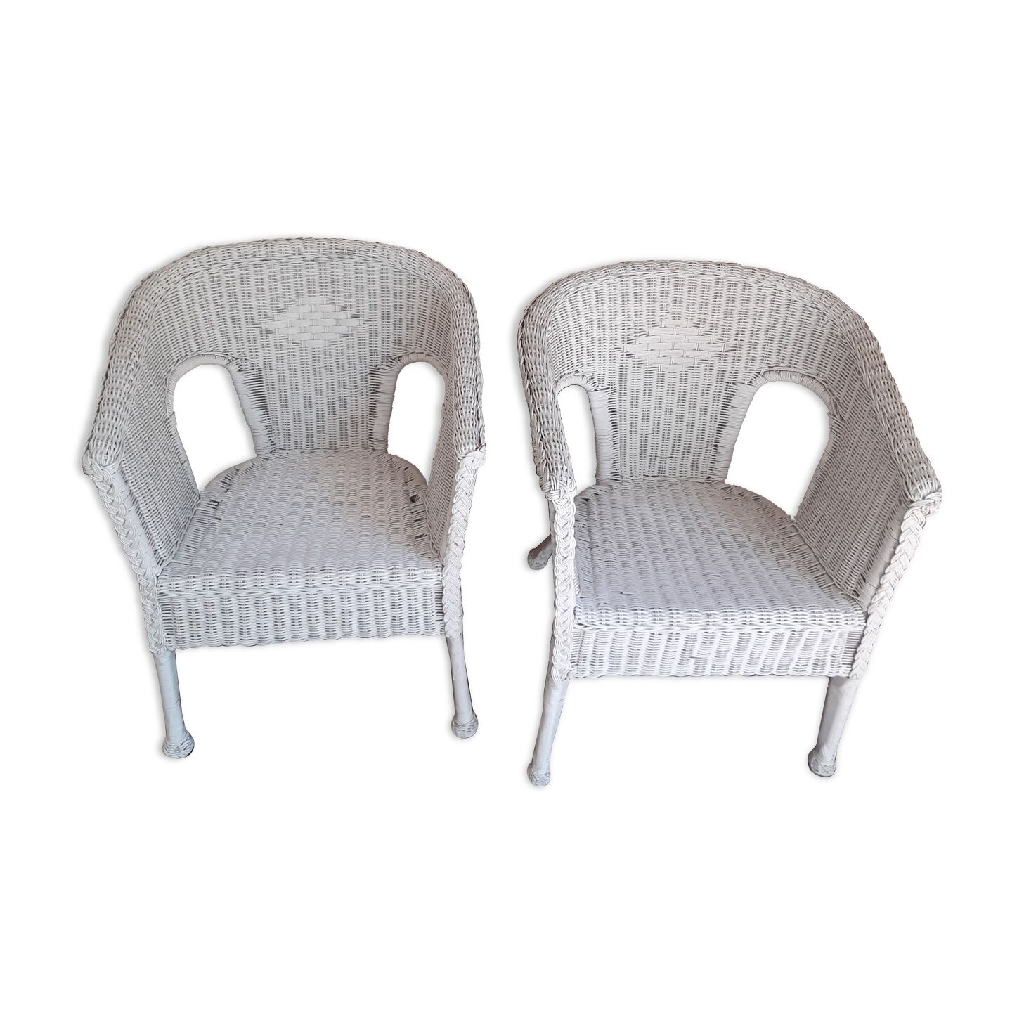 2 white wicker armchairs