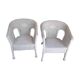 2 white wicker armchairs