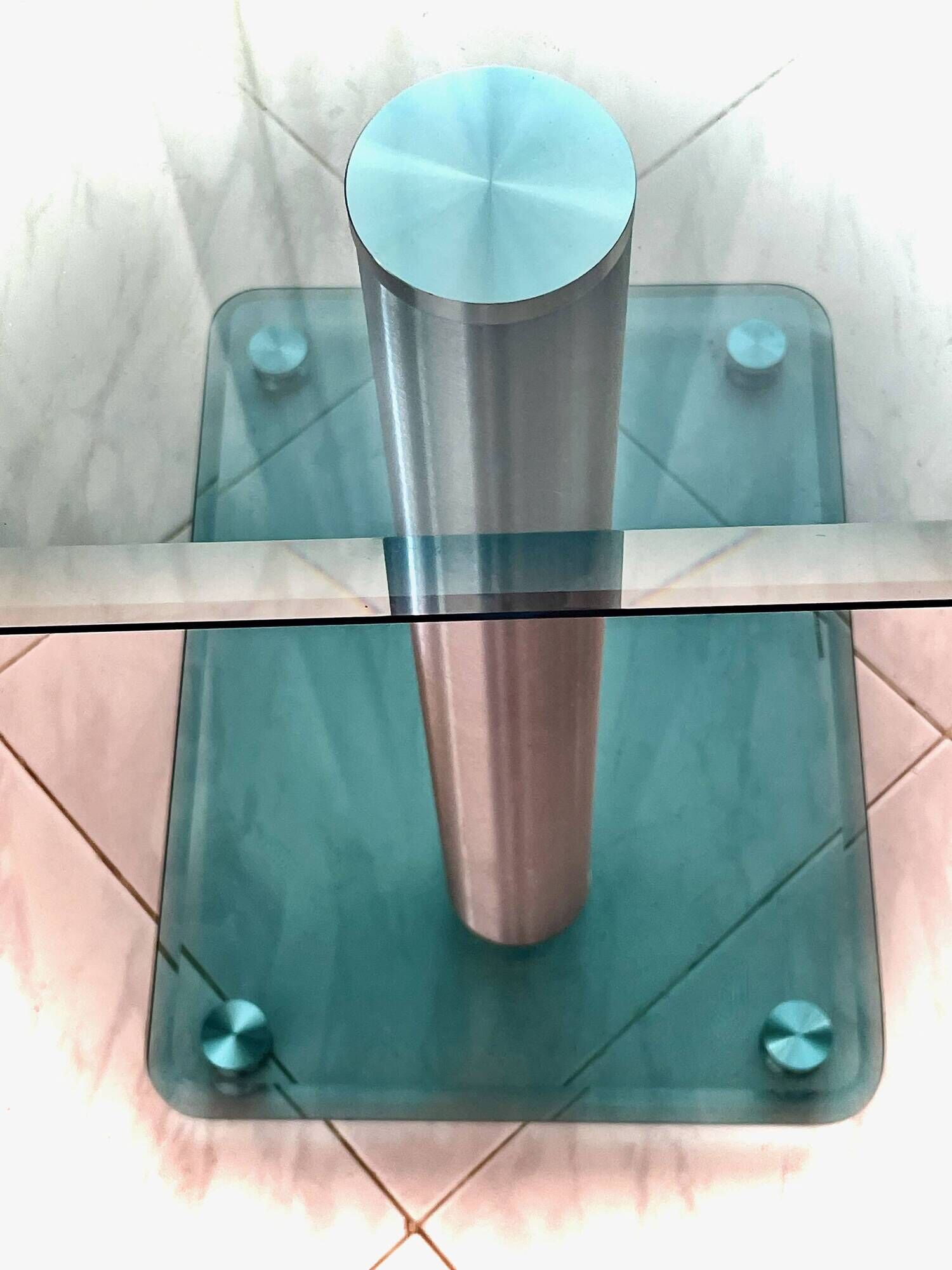 Contemporary square side table in glass with a metallic central column.