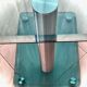 Contemporary square side table in glass with a metallic central column.