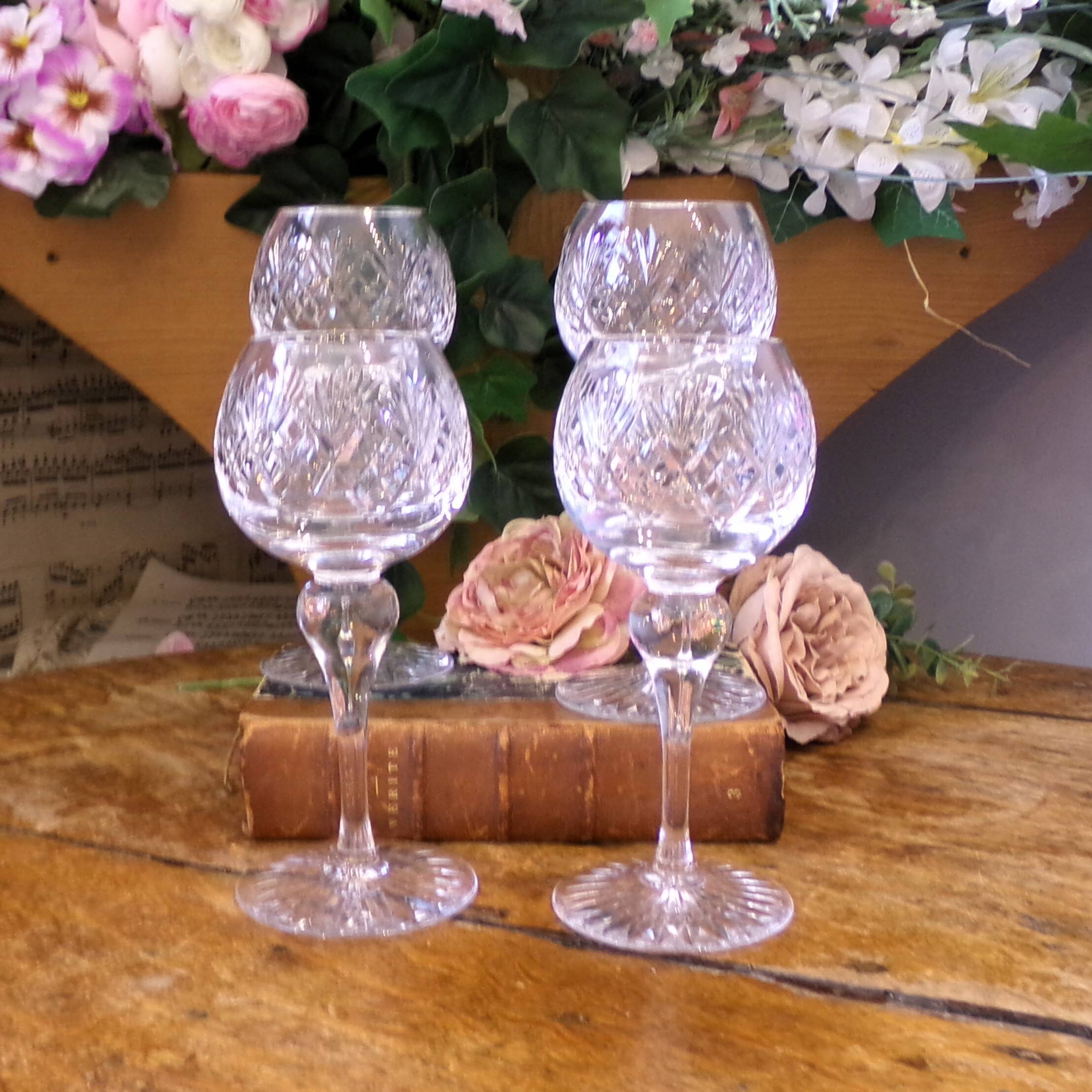4 lead crystal wine glasses with slender baluster stems.