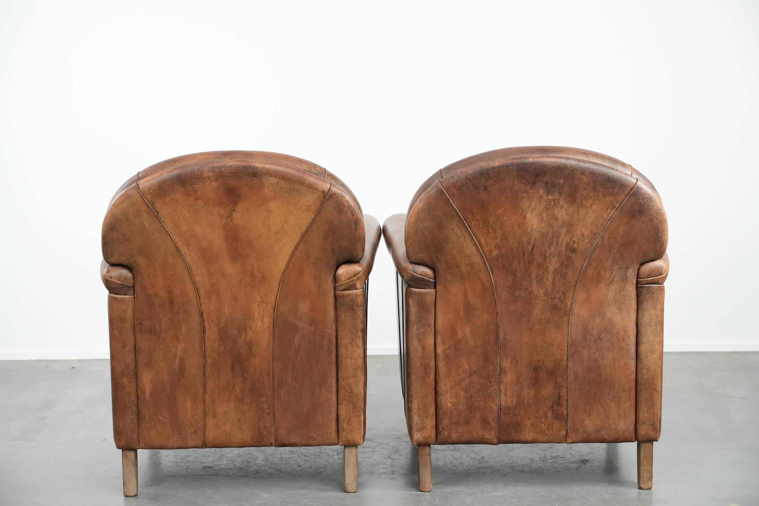Set of 2 vintage sheepskin armchairs with a characterful appearance