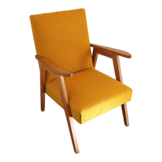 Curly yellow Scandinavian armchair