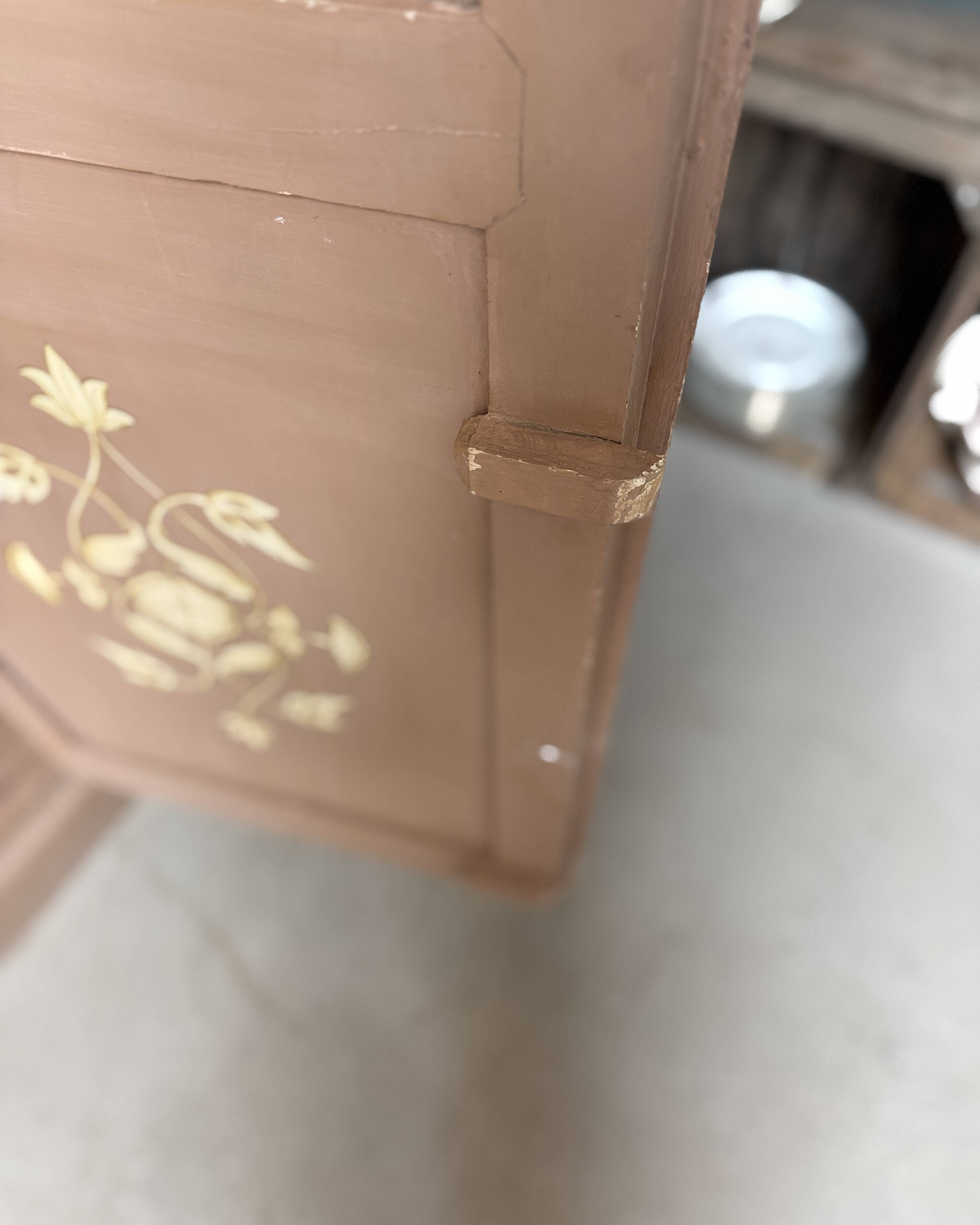 Large antique wardrobe painted with floral decoration.