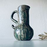 Old pitcher in glazed terracotta