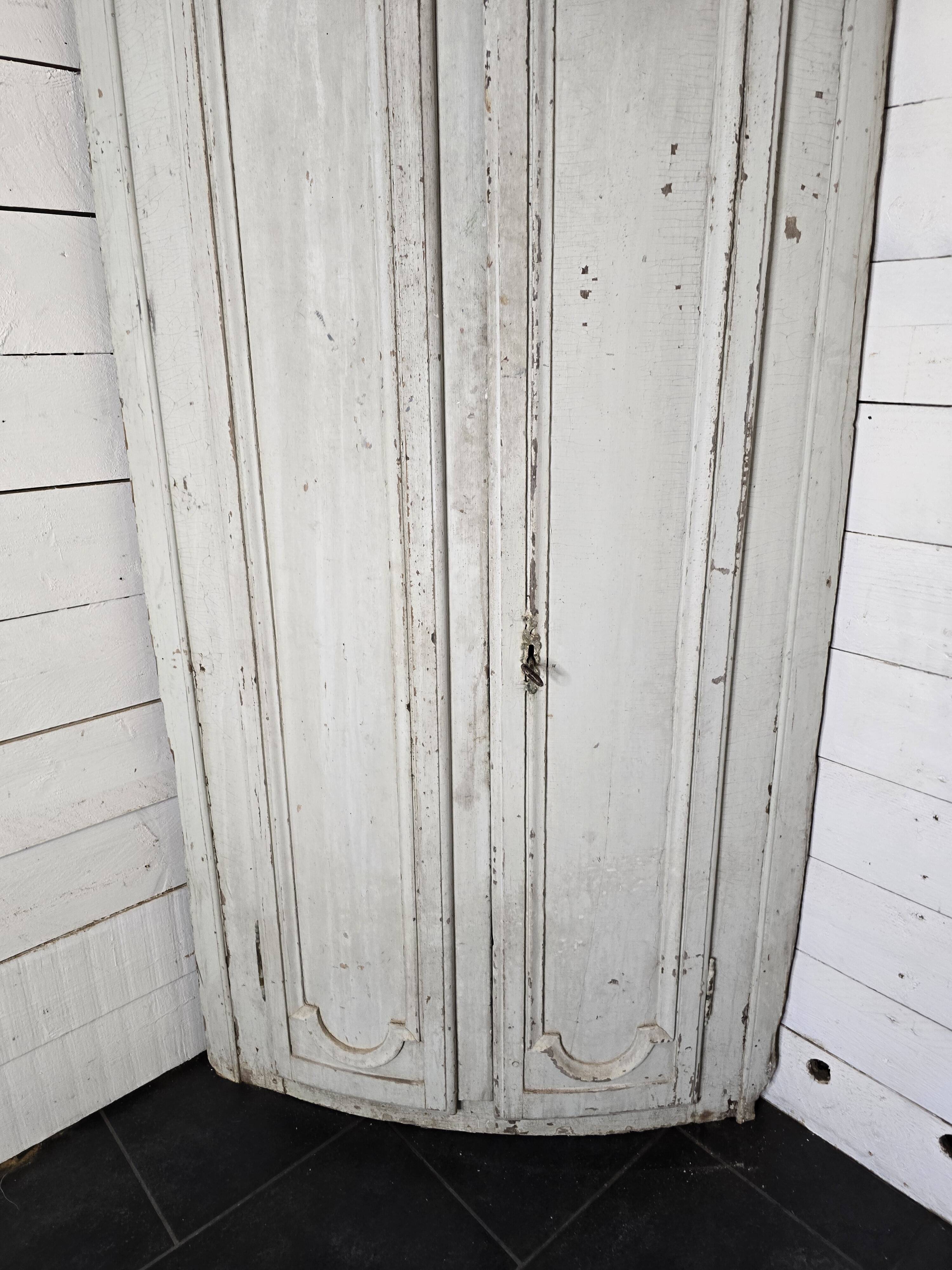 19th century curved corner cupboard in patinated oak