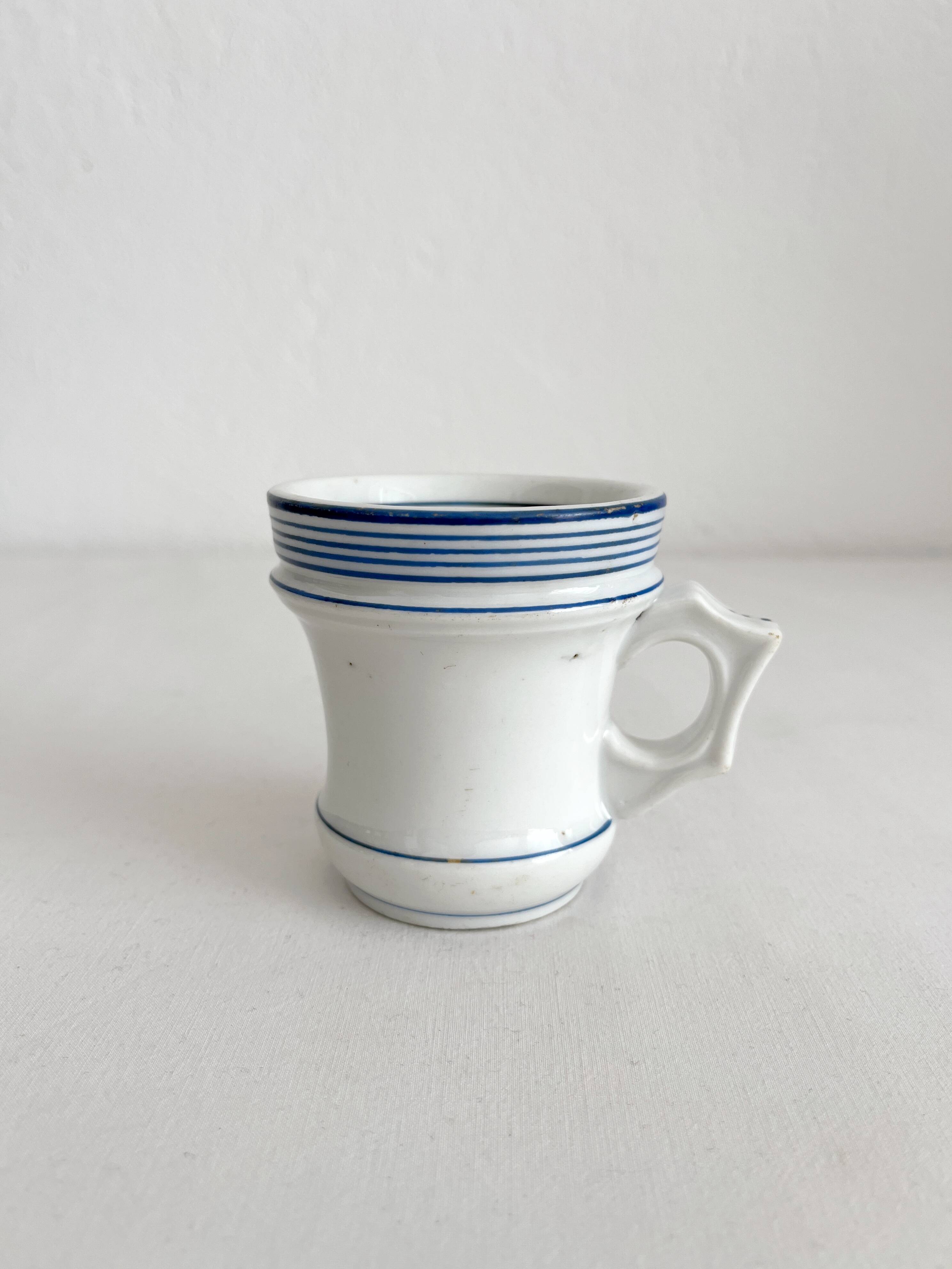 Antique porcelain teacup with blue rims, 19th century