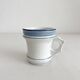 Antique porcelain teacup with blue rims, 19th century