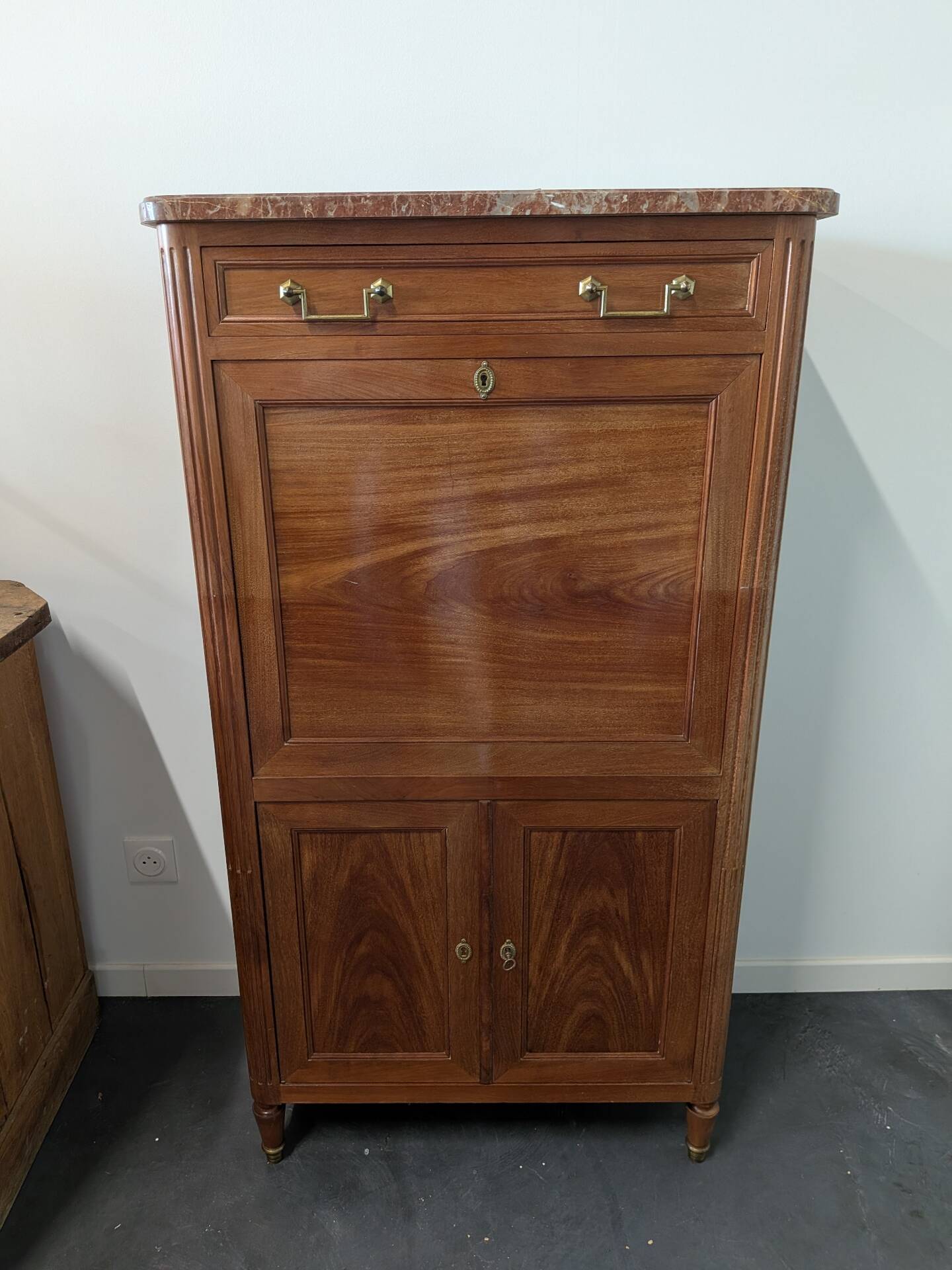 Secretary with a drop-leaf in Louis XVI style made of mahogany and royal red marble.