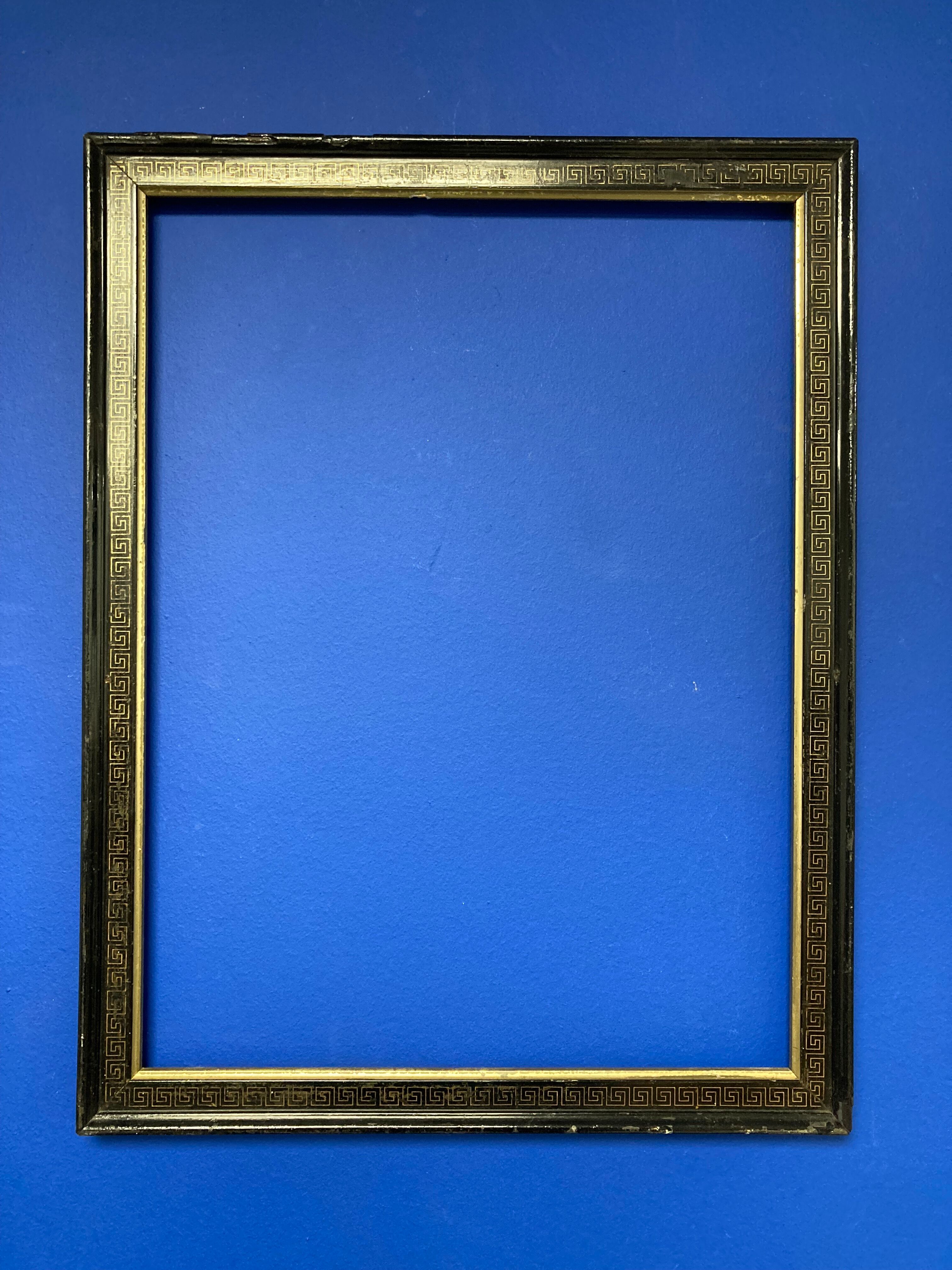 Black and gold frame decorated with Greek frieze decoration