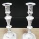 Pair of patinated white candlesticks