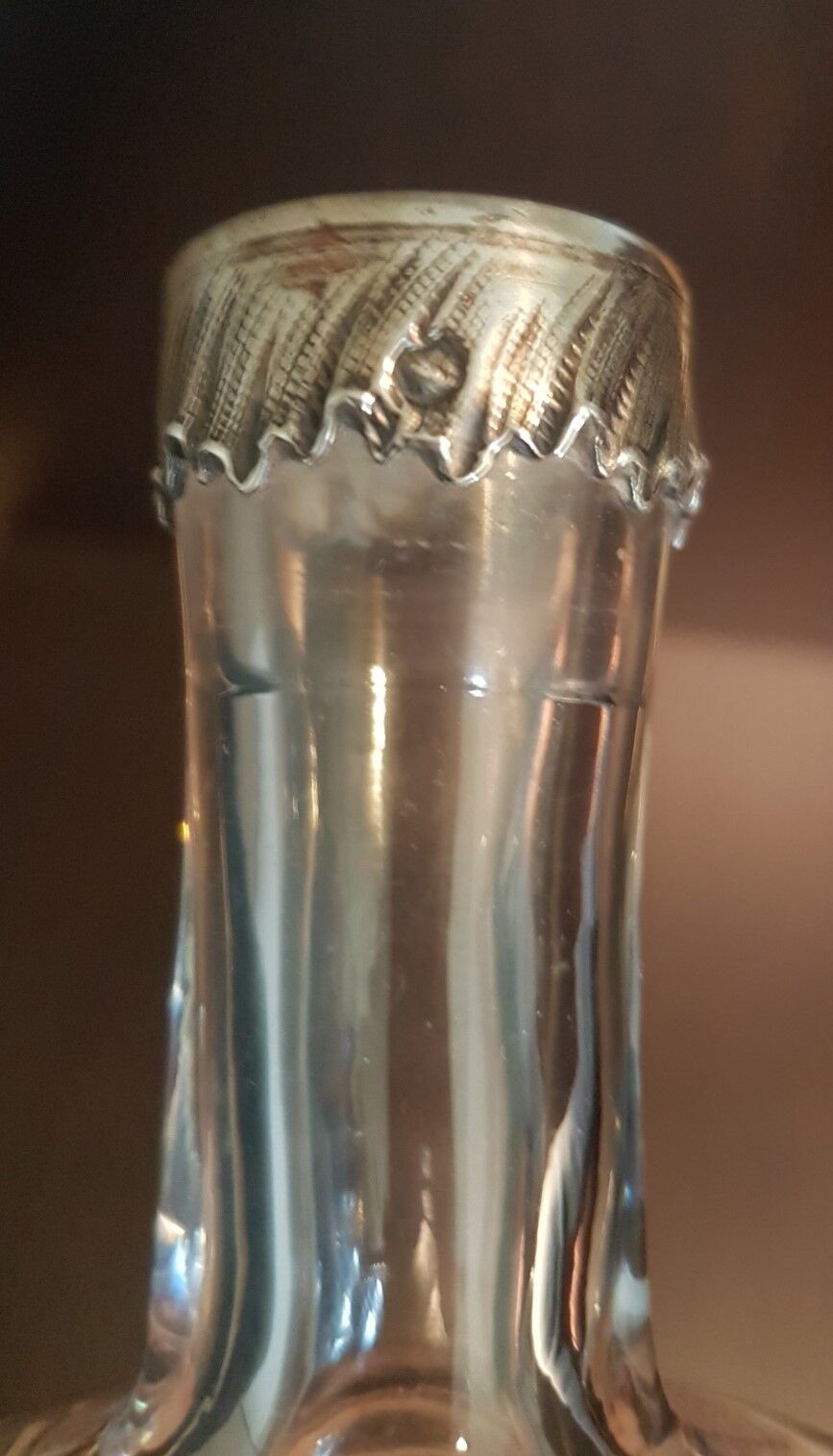 Molded glass carafe with silver frame