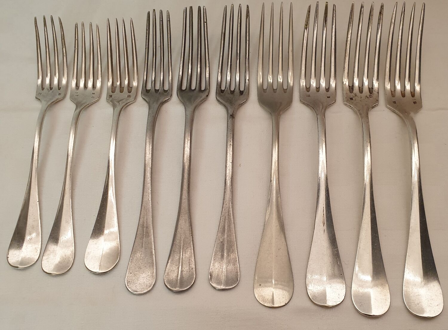 10 mismatched silver metal forks