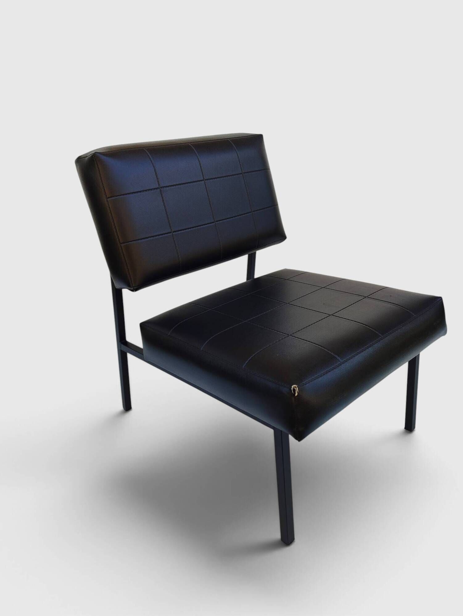 Modernist armchair in black faux leather and metal – 1960s