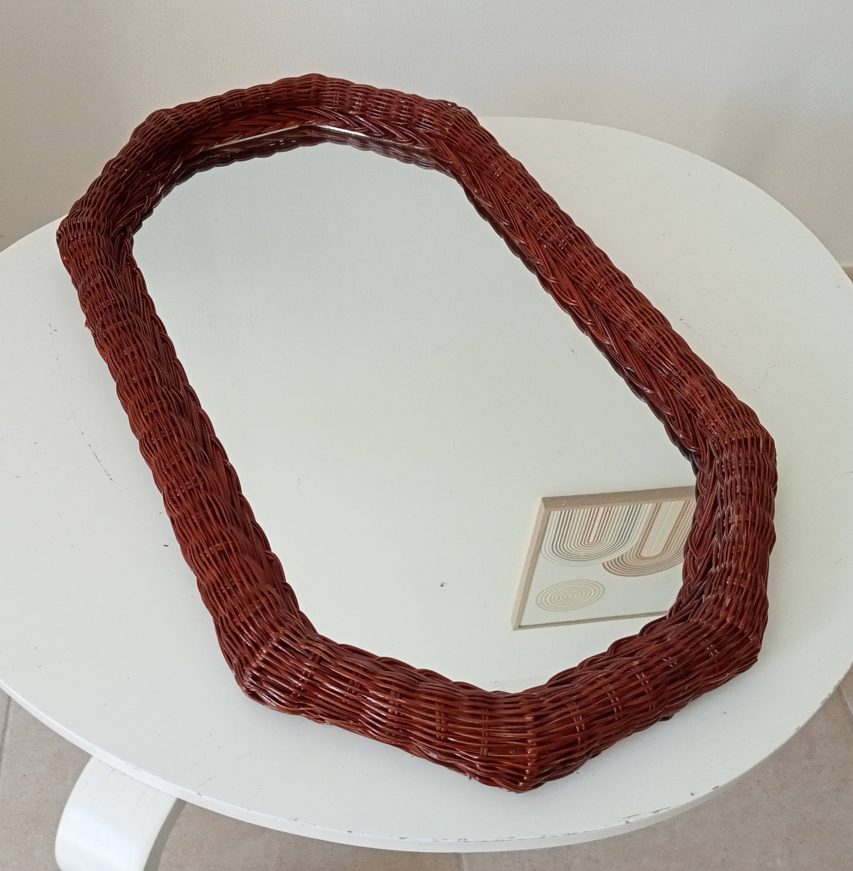 Vintage octagonal mirror in woven rattan.