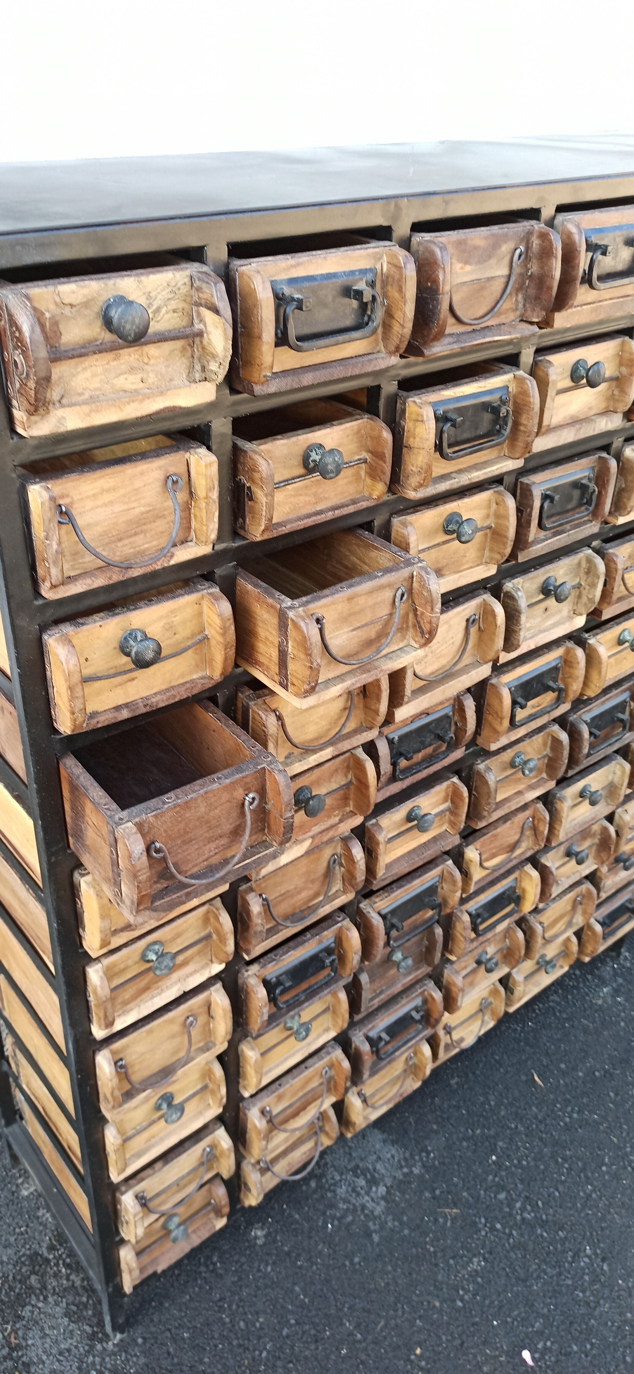 Black metal storage cabinet with 60 wooden drawers