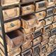 Black metal storage cabinet with 60 wooden drawers