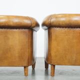 Set of 2 cognac-colored sheepskin club chairs with colorful fabric cushions