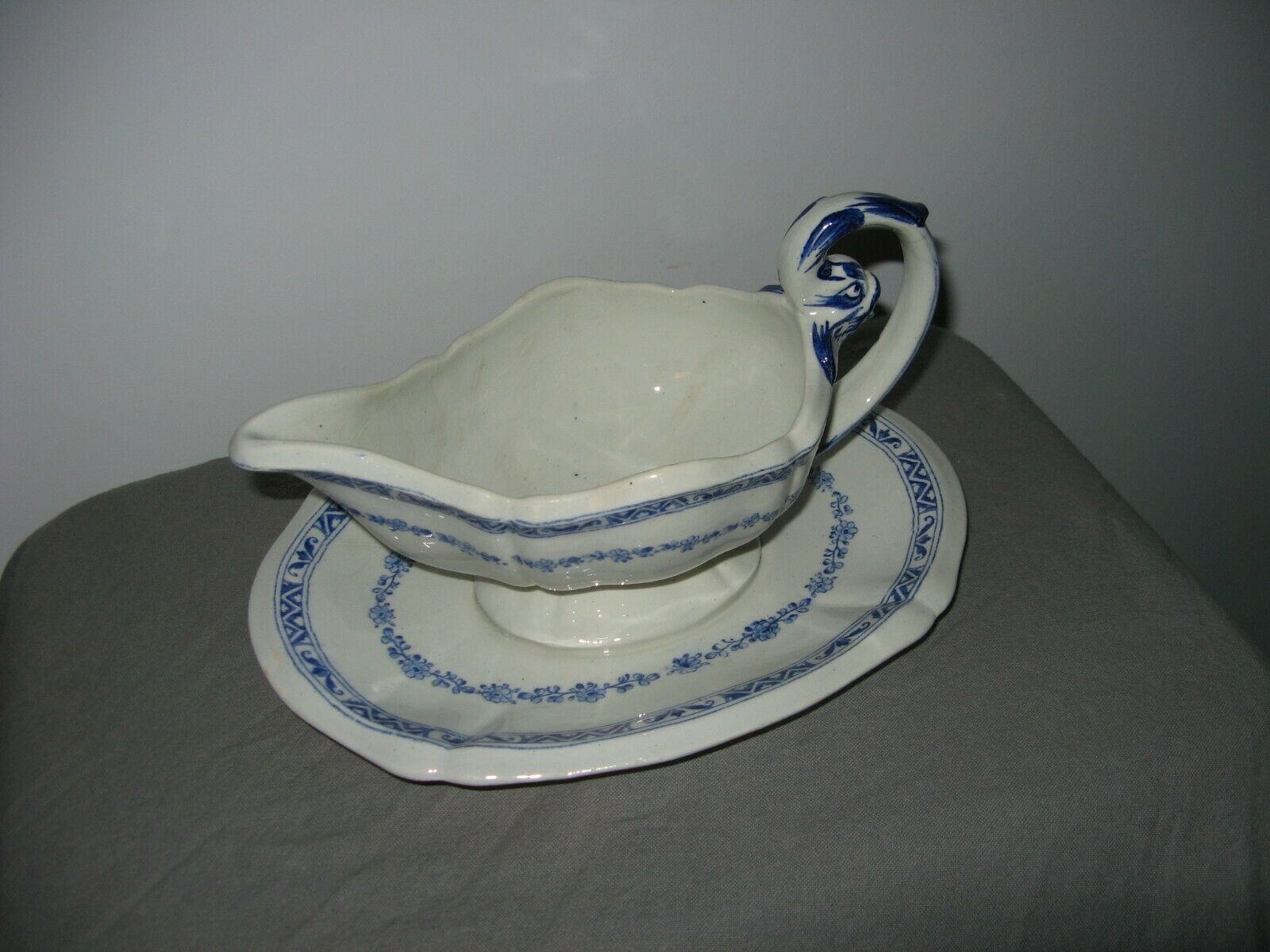 Saucière in Gien earthenware anse in the shape of a dolphin decoration garland 1900