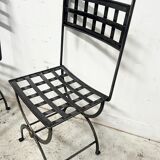 Set of four wrought iron chairs, with a reclining X-shaped base, seat and backrest.