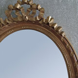 Oval mirror in carved and gilded wood in Louis XVI style