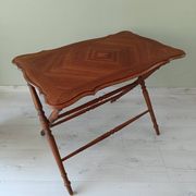 Vintage folding table with turned legs.