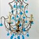 Italian chandelier with blue beads and gilded wood.