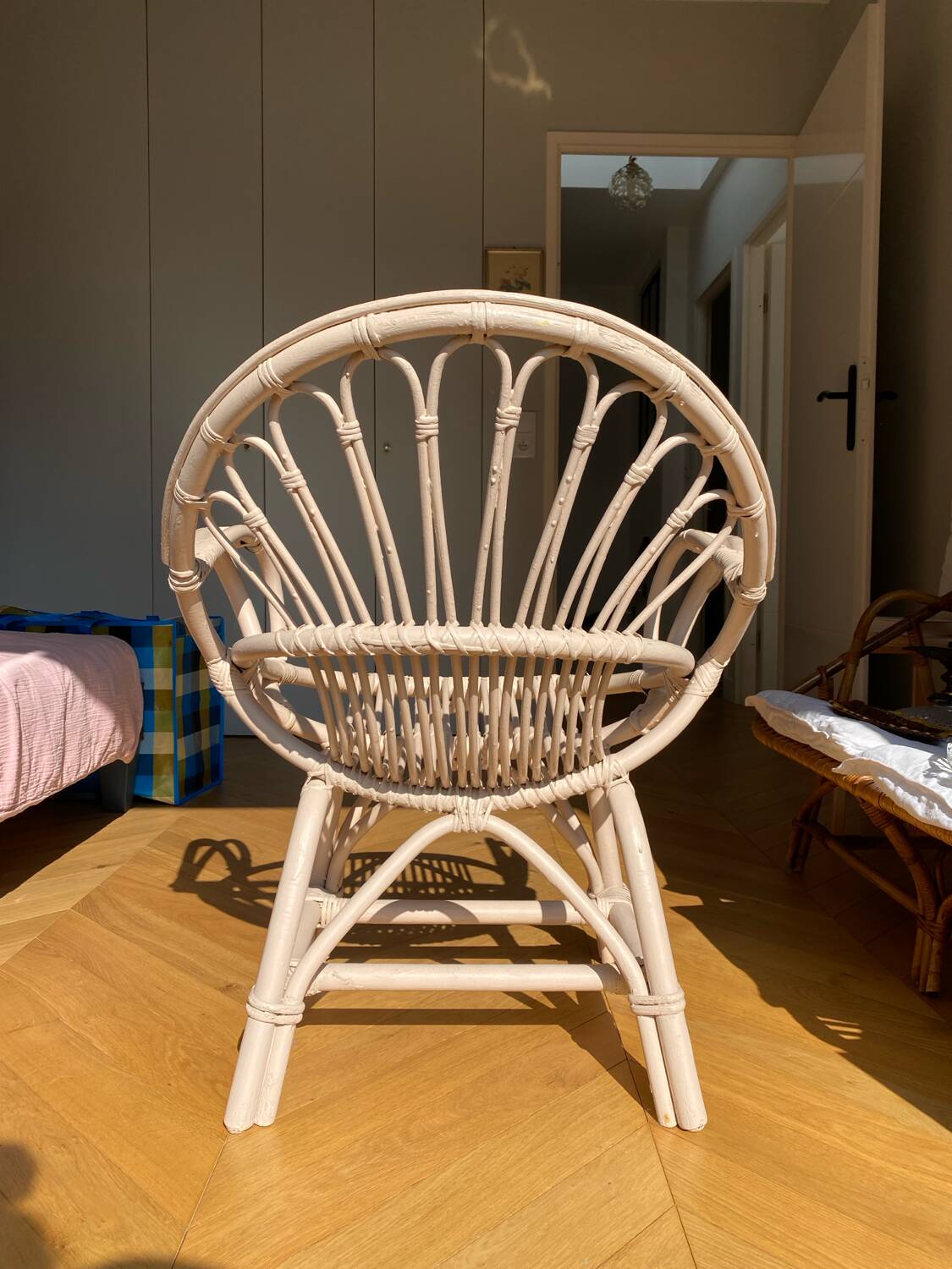 Shell chair in pale pink painted rattan