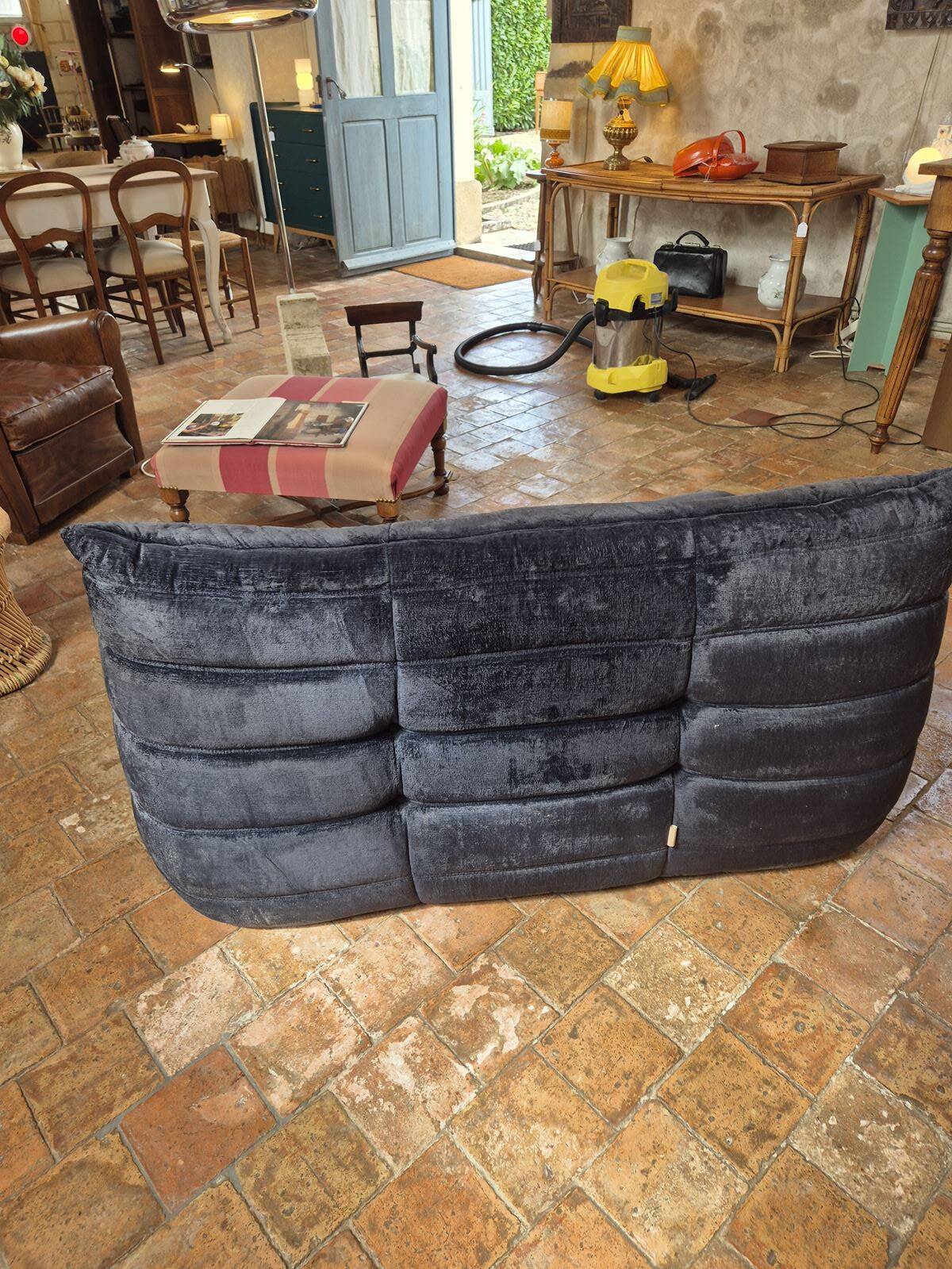 Togo sofa by Ligne Roset and its pouf from the 1970s.