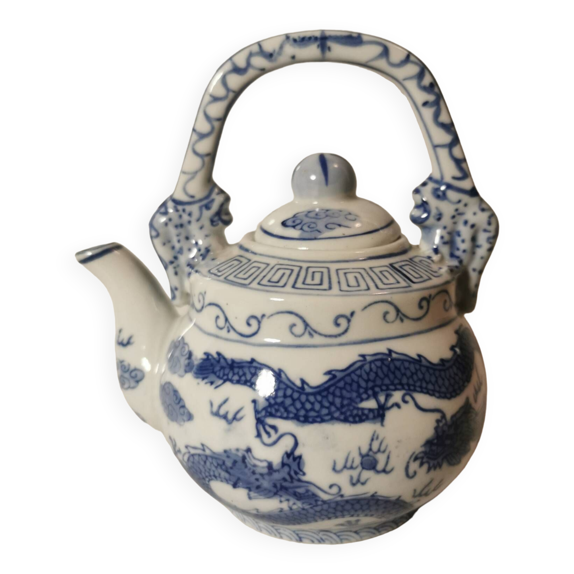 Old Chinese blue and white teapot in vintage ceramic with dragon decor