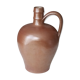Old pitcher pitcher in varnished sandstone