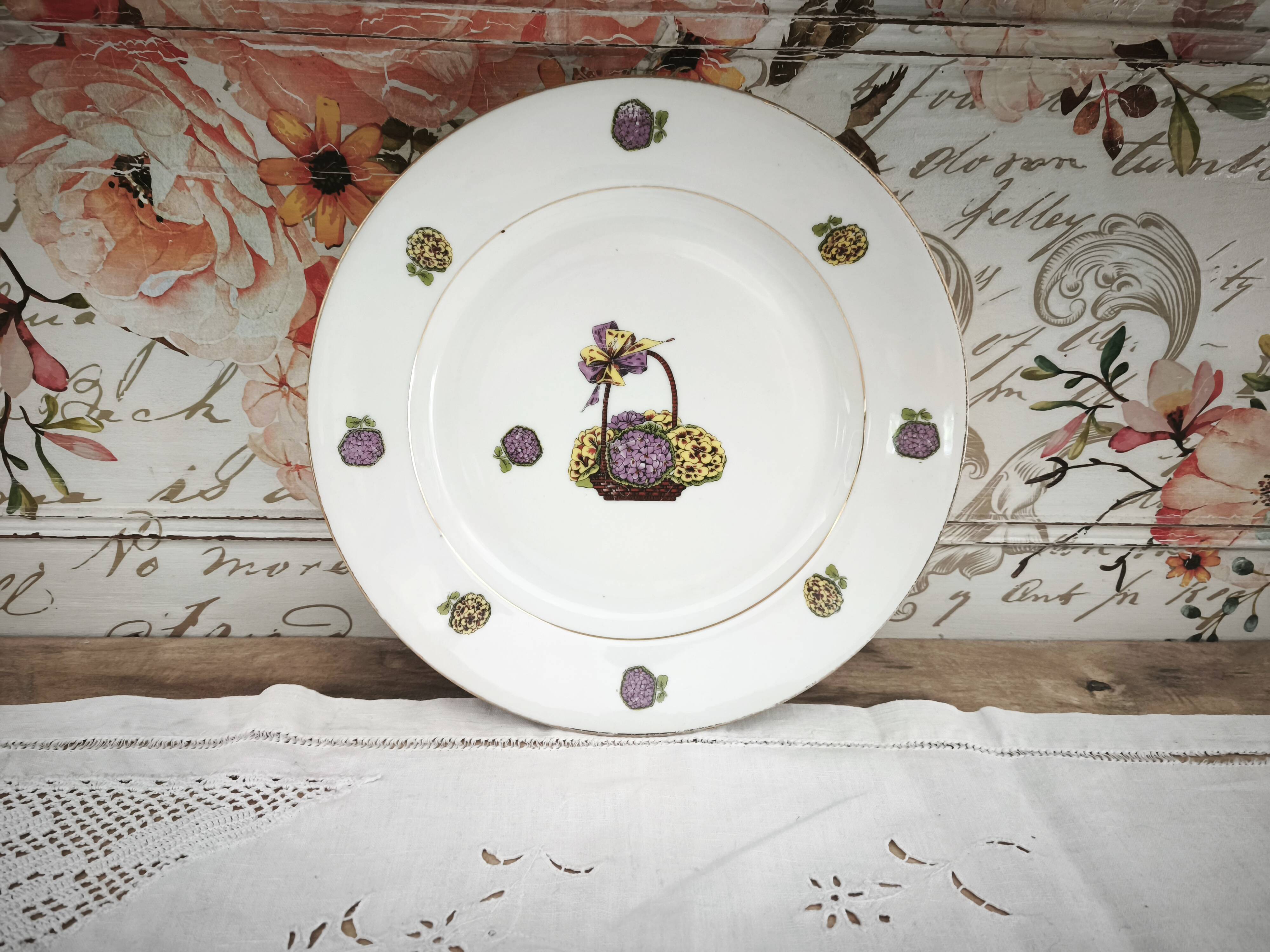 Round porcelain plate from Limoges with a hydrangea basket design.
