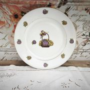 Round porcelain plate from Limoges with a hydrangea basket design.