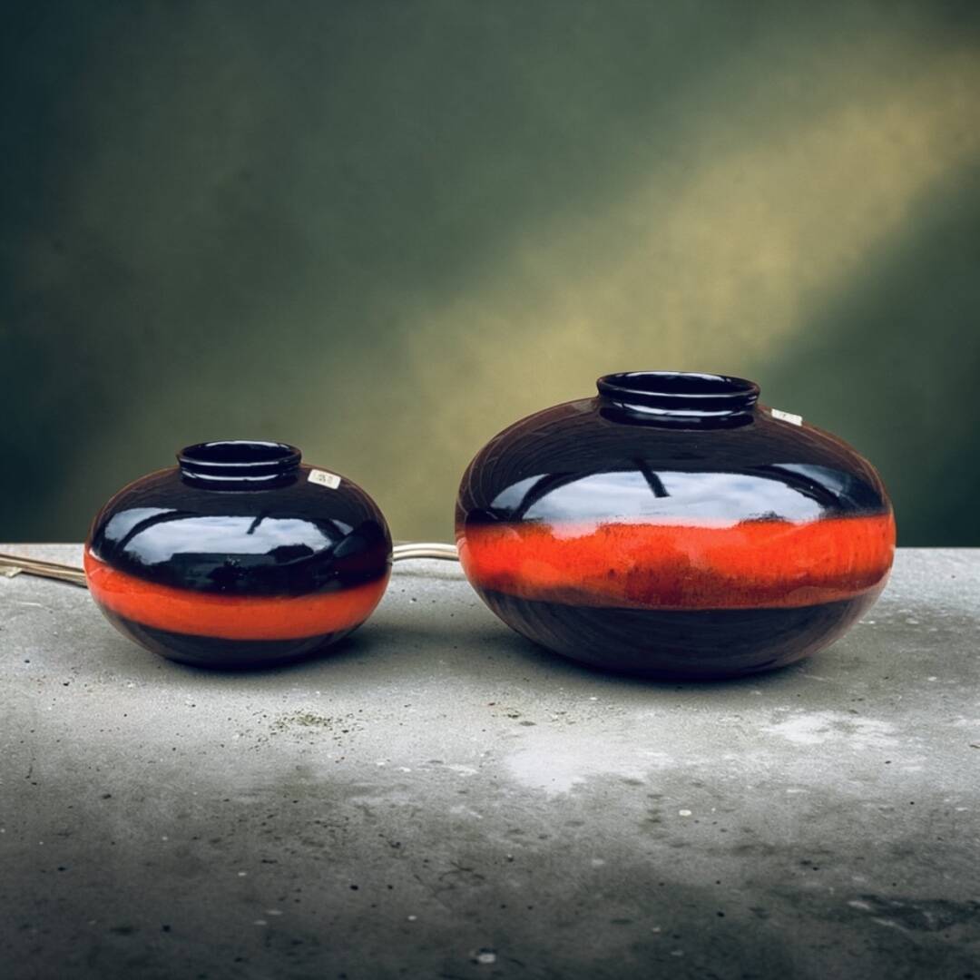 A pair of black and red spherical vases by Bay Keramik, West Germany, from the 1960s.
