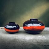 A pair of black and red spherical vases by Bay Keramik, West Germany, from the 1960s.