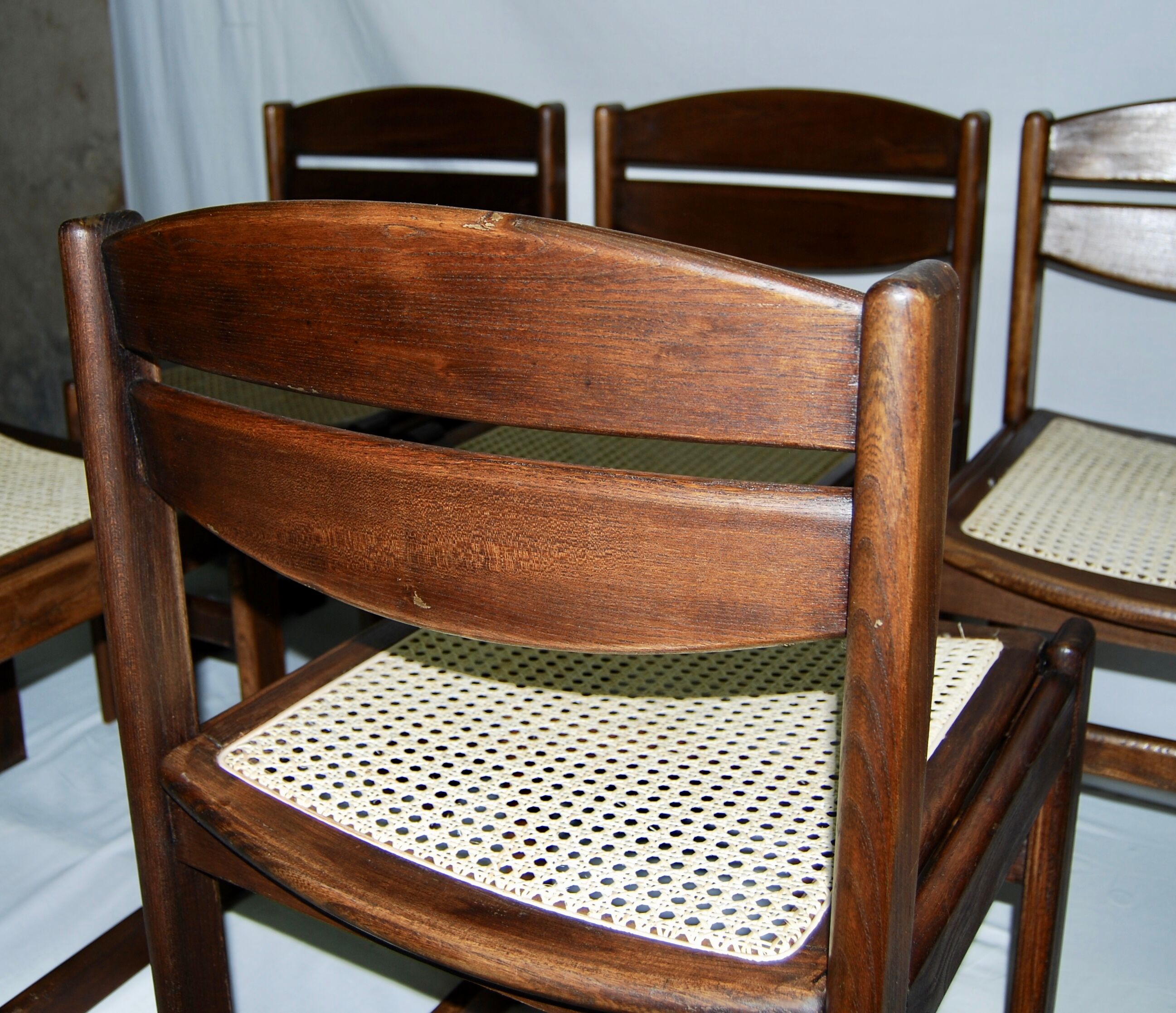 Set of 12 "sledge" dining chairs in walnut and cane.