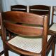 Set of 12 "sledge" dining chairs in walnut and cane.