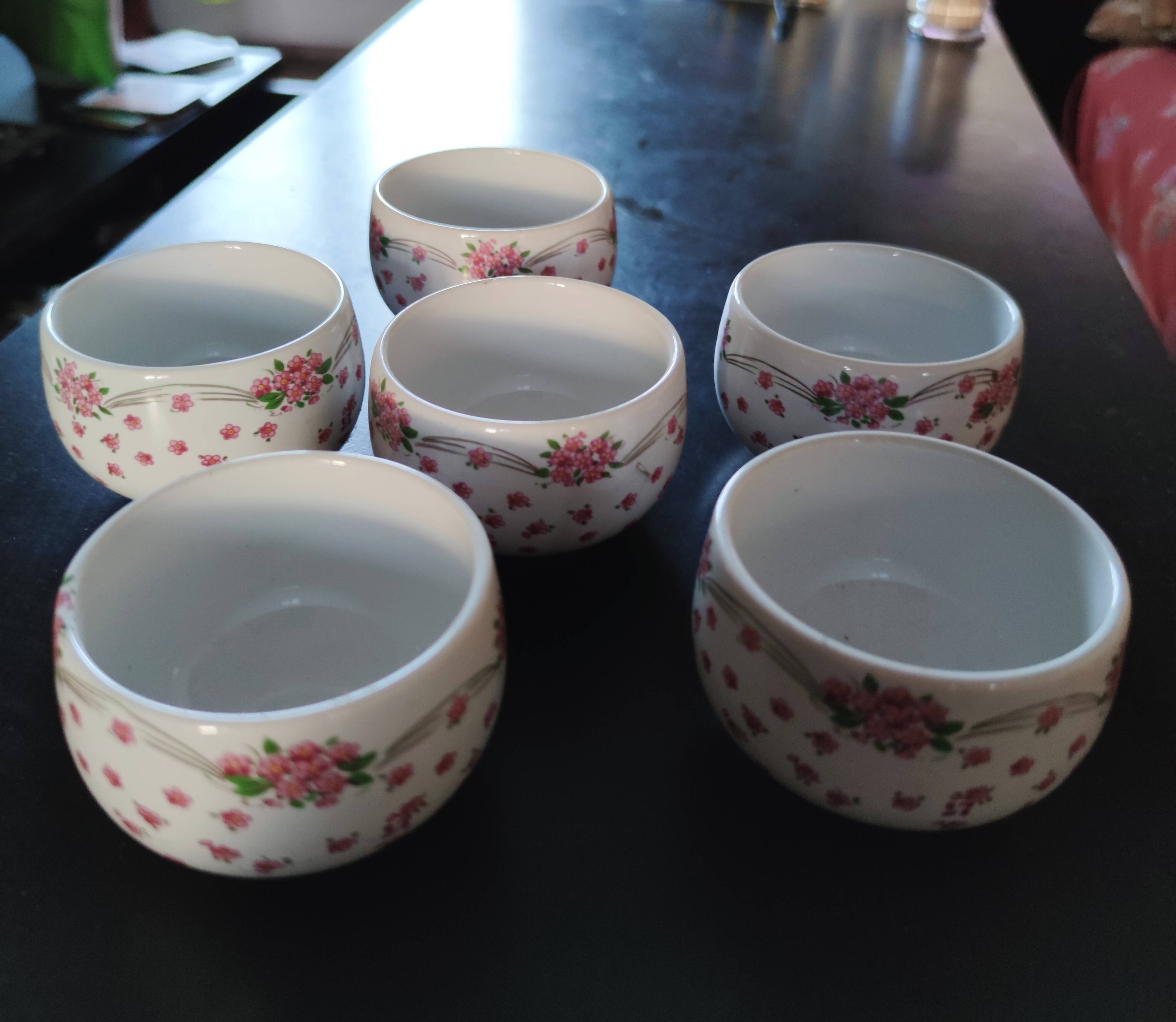 Service of small six cups for tea, cream, fruit salad or coffee
