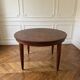 Oval extendable dining table in wood and walnut burl veneer.
