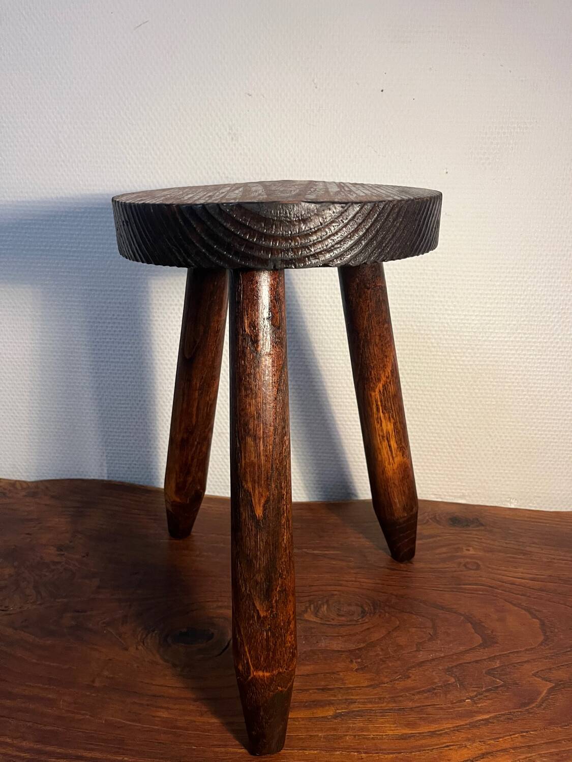 Round wooden tripod stool