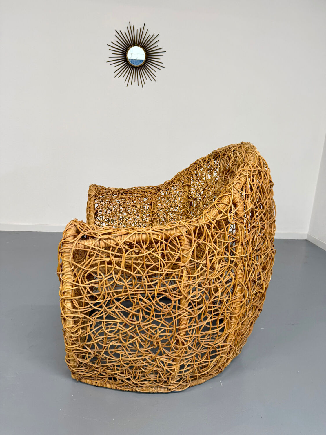 Sculptural woven rattan armchair, organic design from the 1970s.