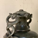 Bronze vase with snakes and a green patina, in the antique style.