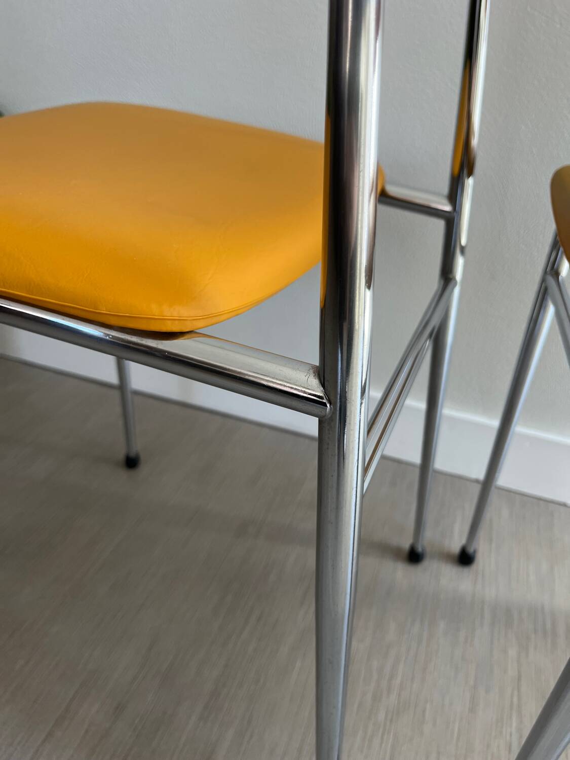 LM vintage chrome and orange/mustard yellow faux leather chairs