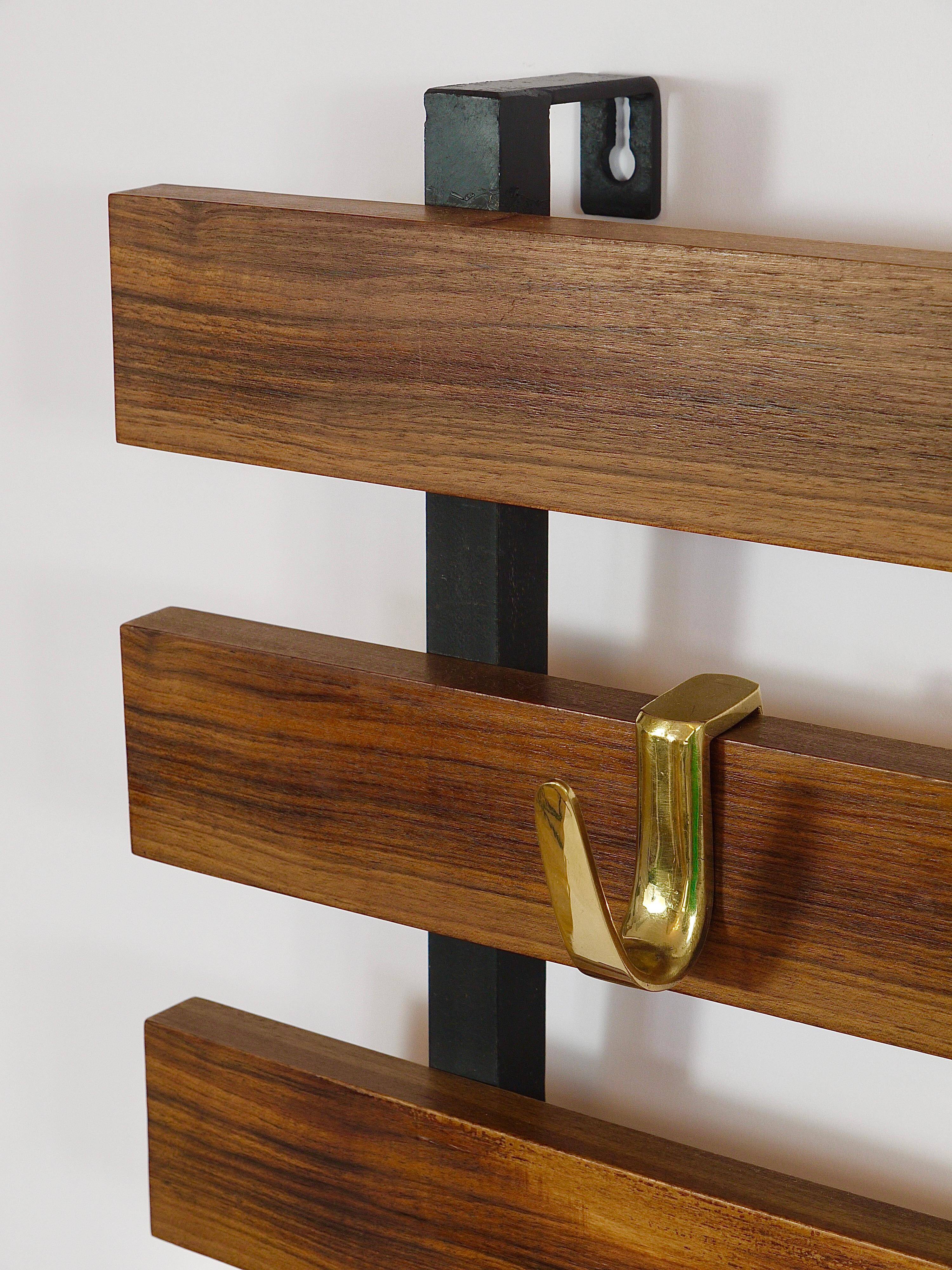 Wall coat rack by Carl Aubock with 5 brass hooks, walnut, iron, Austria, 1950s.