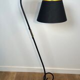 Design floor lamp in black lacquered metal and brass.