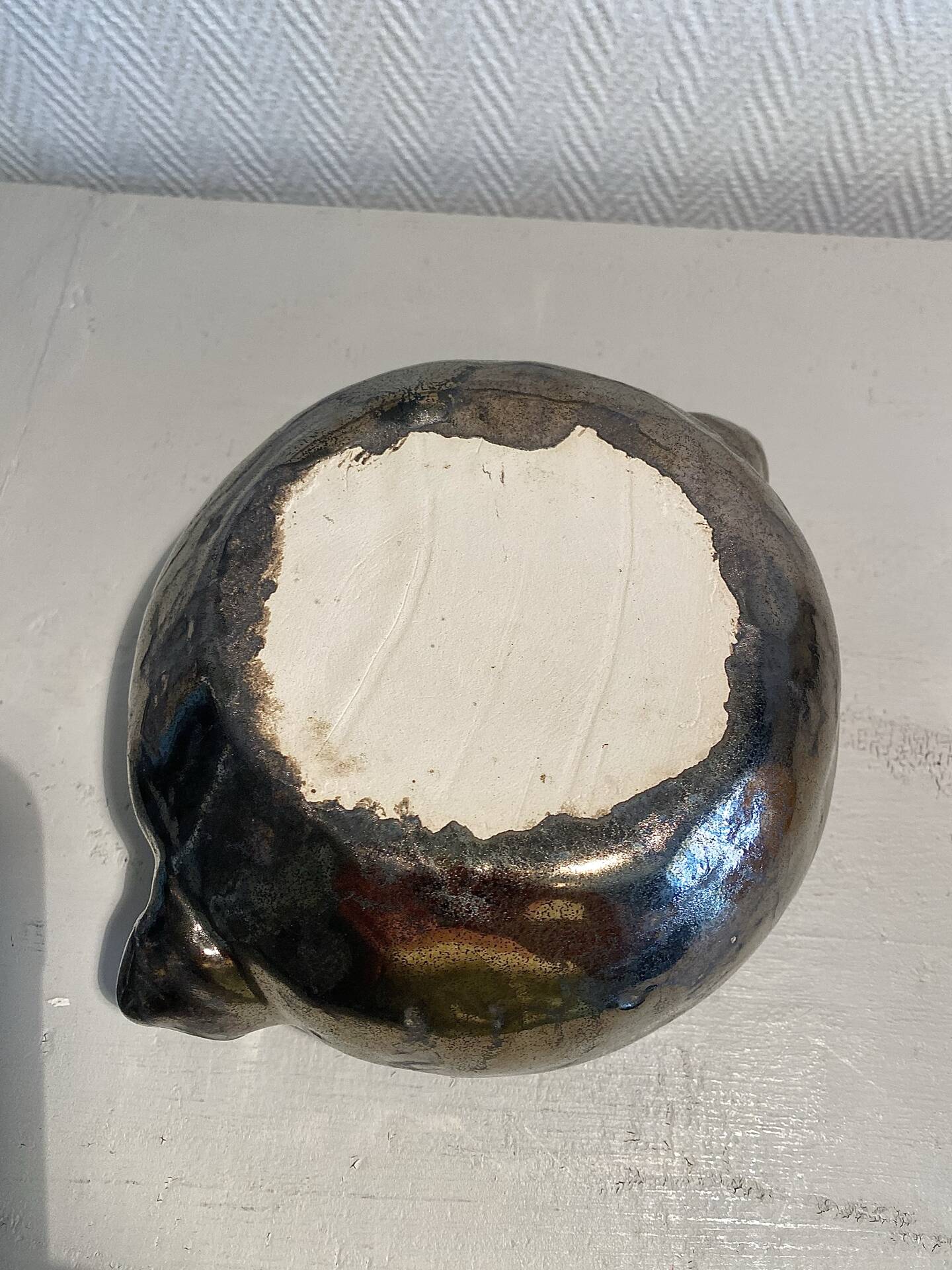 Deep red glazed and metallic ceramic catchall.
