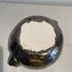 Deep red glazed and metallic ceramic catchall.