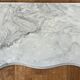 Carved wooden console and gray marble