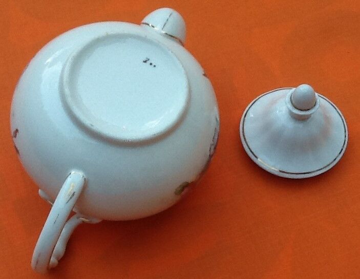 Old porcelain teapot with floral decoration